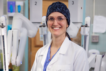 Dr. Lana Šačiragić stands with the da Vinci Xi surgical robot at the QEII. 